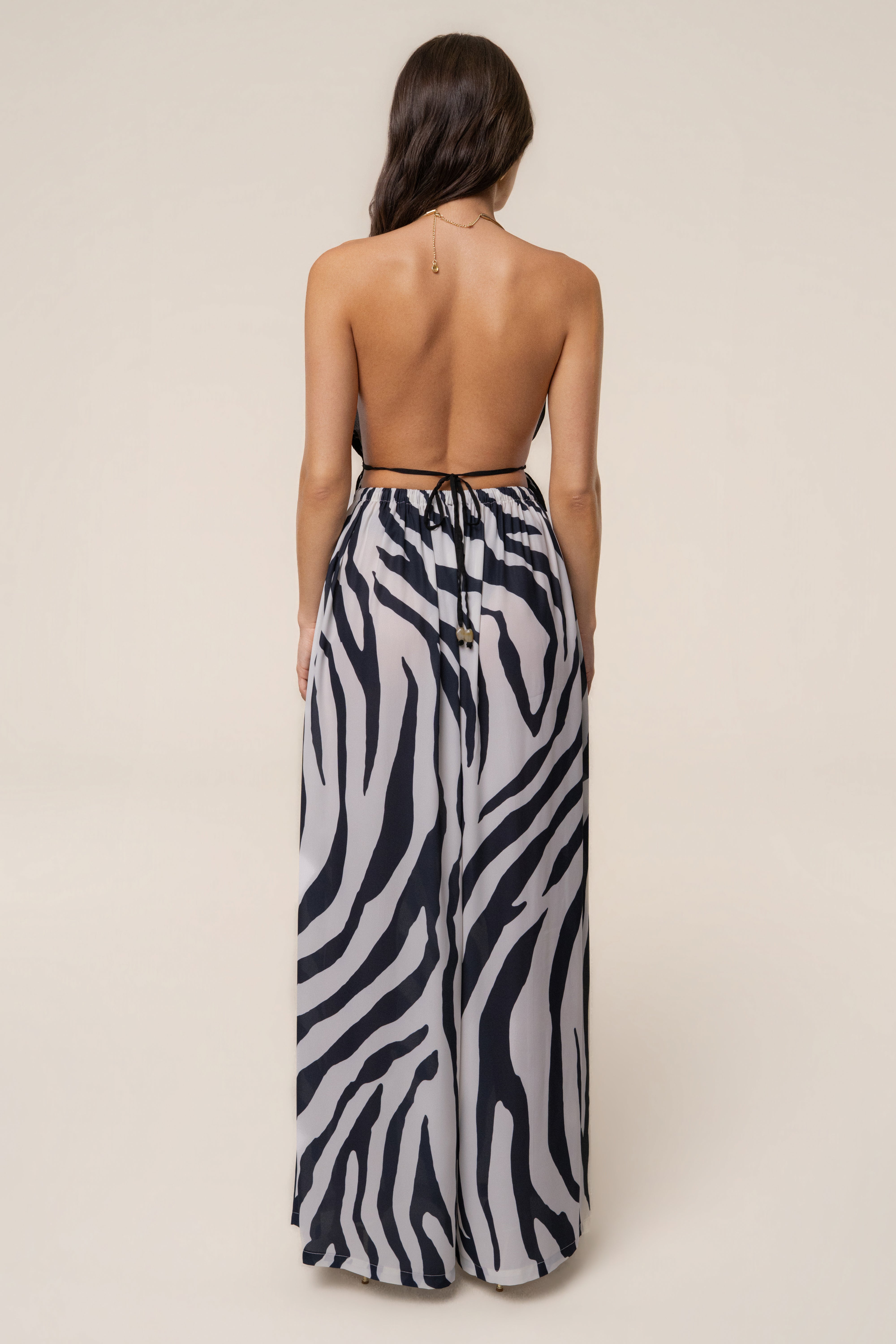 Navy zebra print resort glow chiffon pants from JLUXLABEL displayed on a model, featuring flowy fabric and relaxed fit.