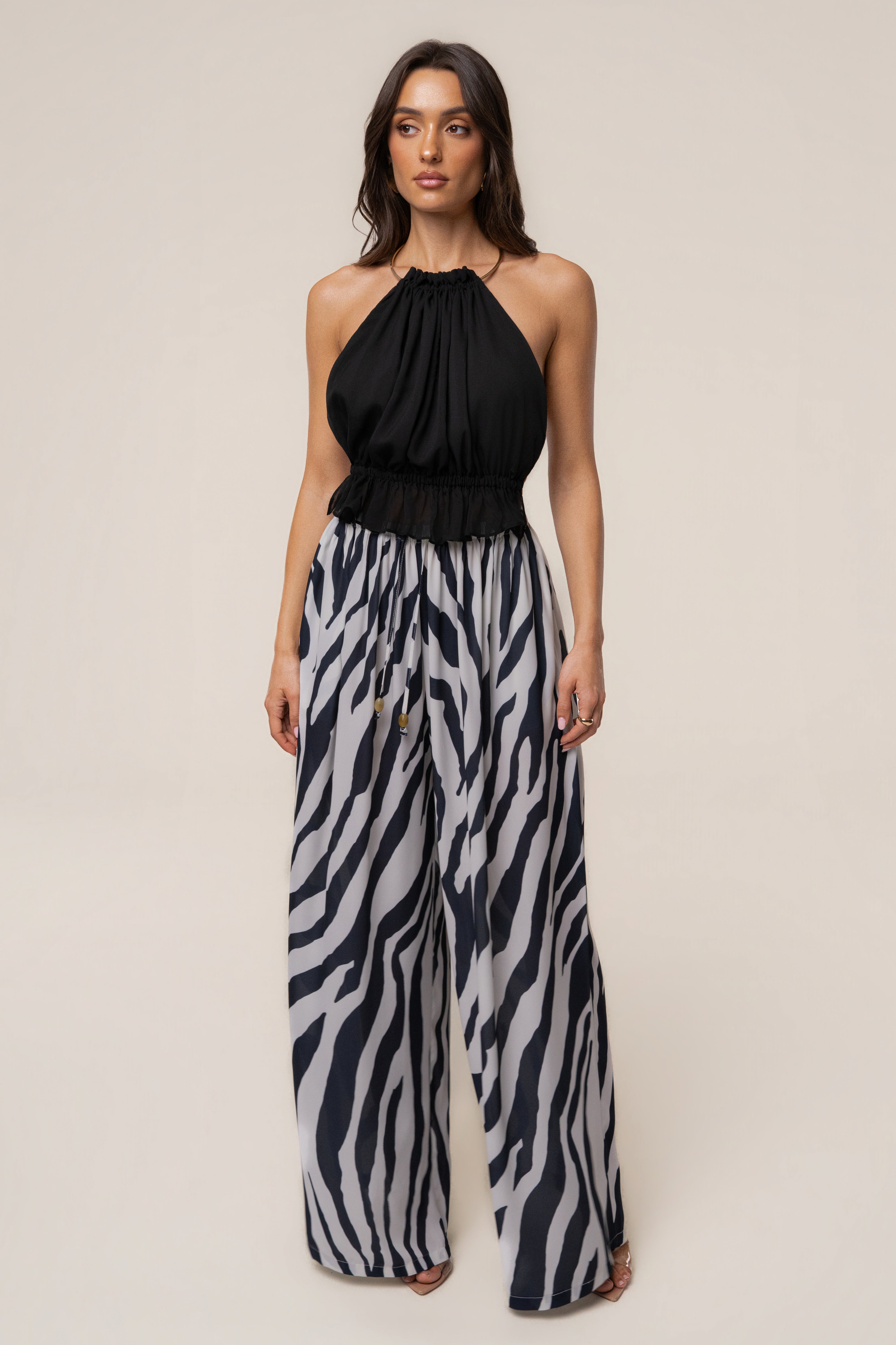 Navy zebra print resort glow chiffon pants from JLUXLABEL, flowy bottoms with a relaxed fit and stylish zebra pattern.