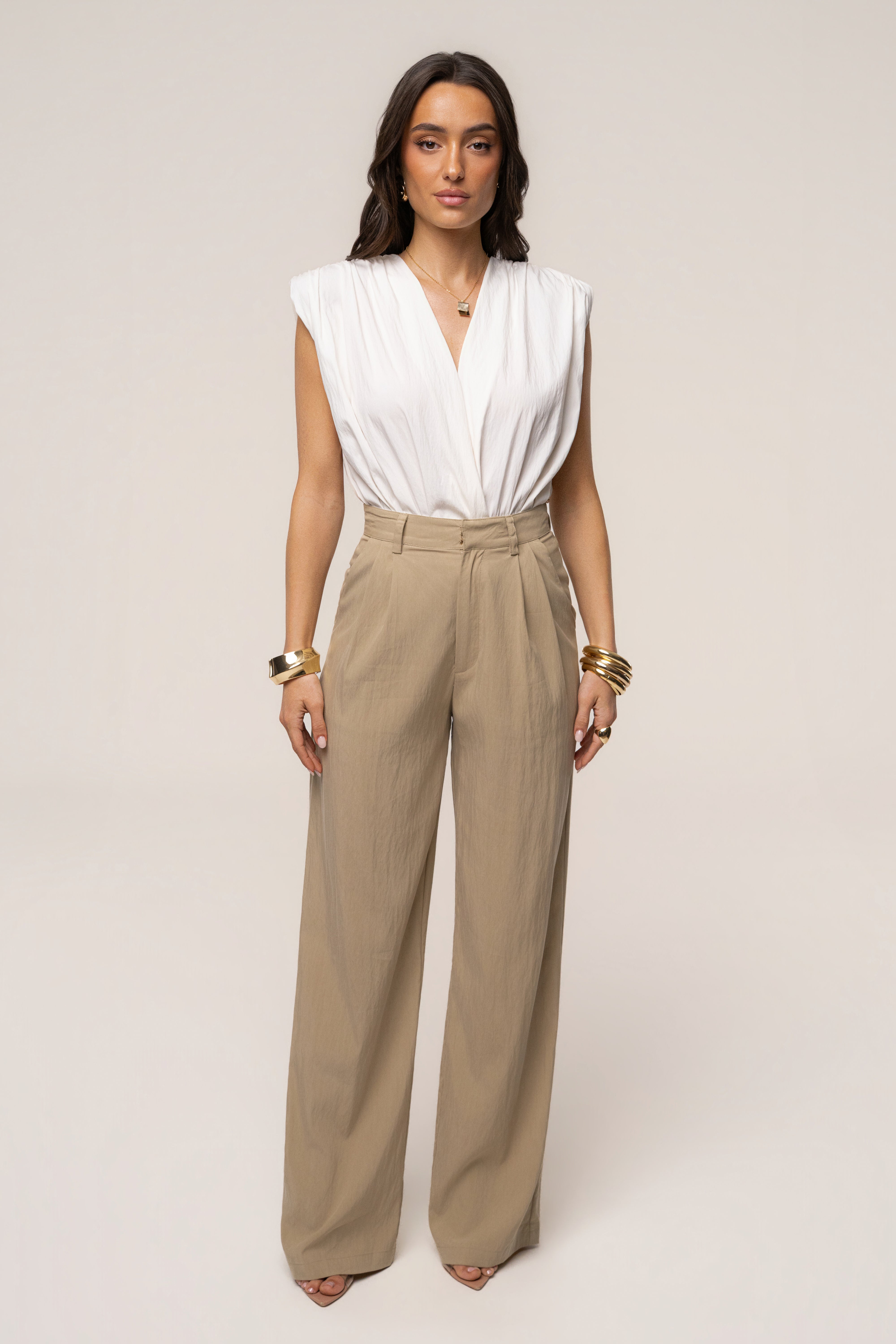 Ivory solar drift bodysuit by JLUXLABEL, featuring a fitted top with a sleek design and subtle detailing.