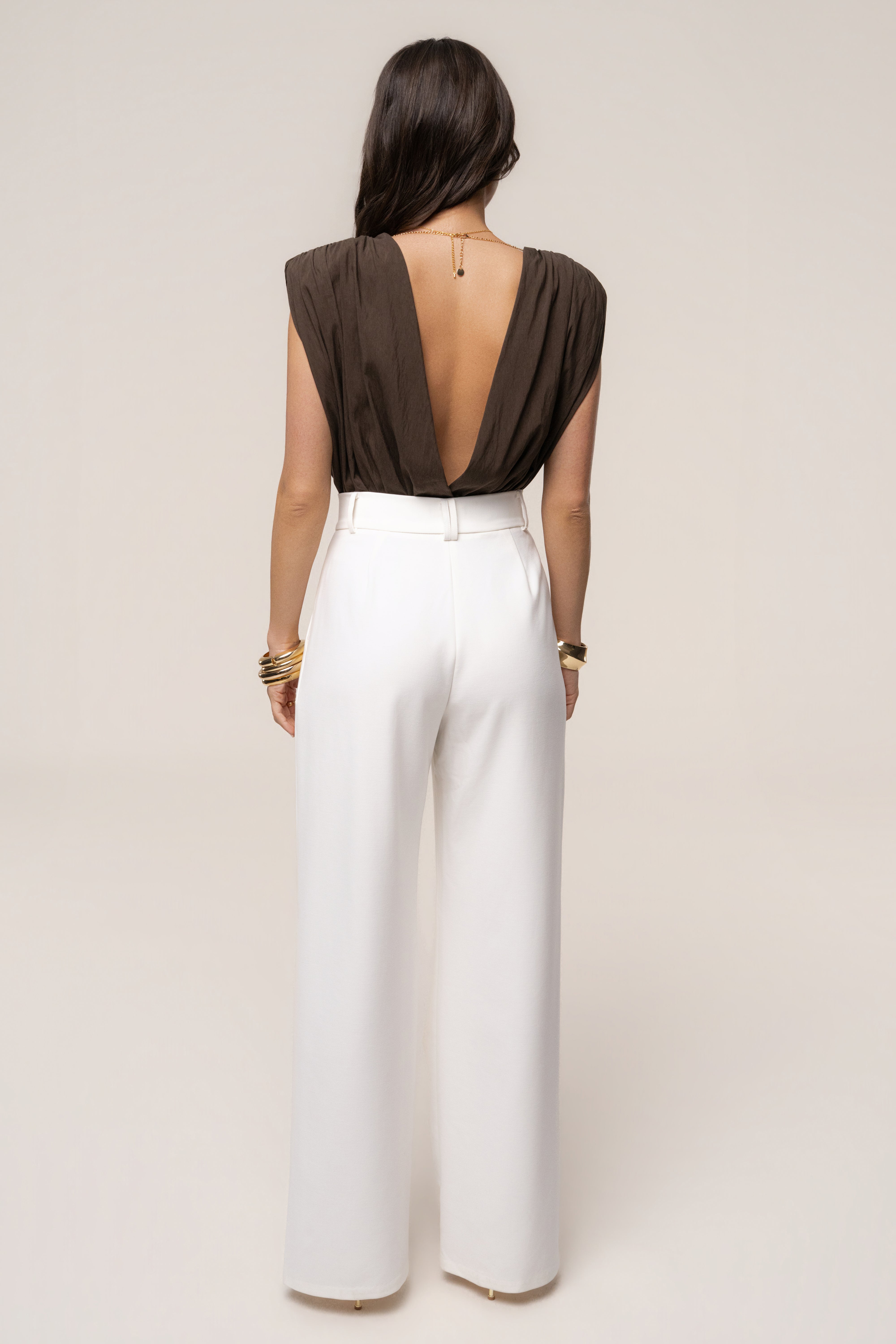 Brown Solar Drift bodysuit by JLUXLABEL, featuring a fitted design with long sleeves and a scoop neckline.