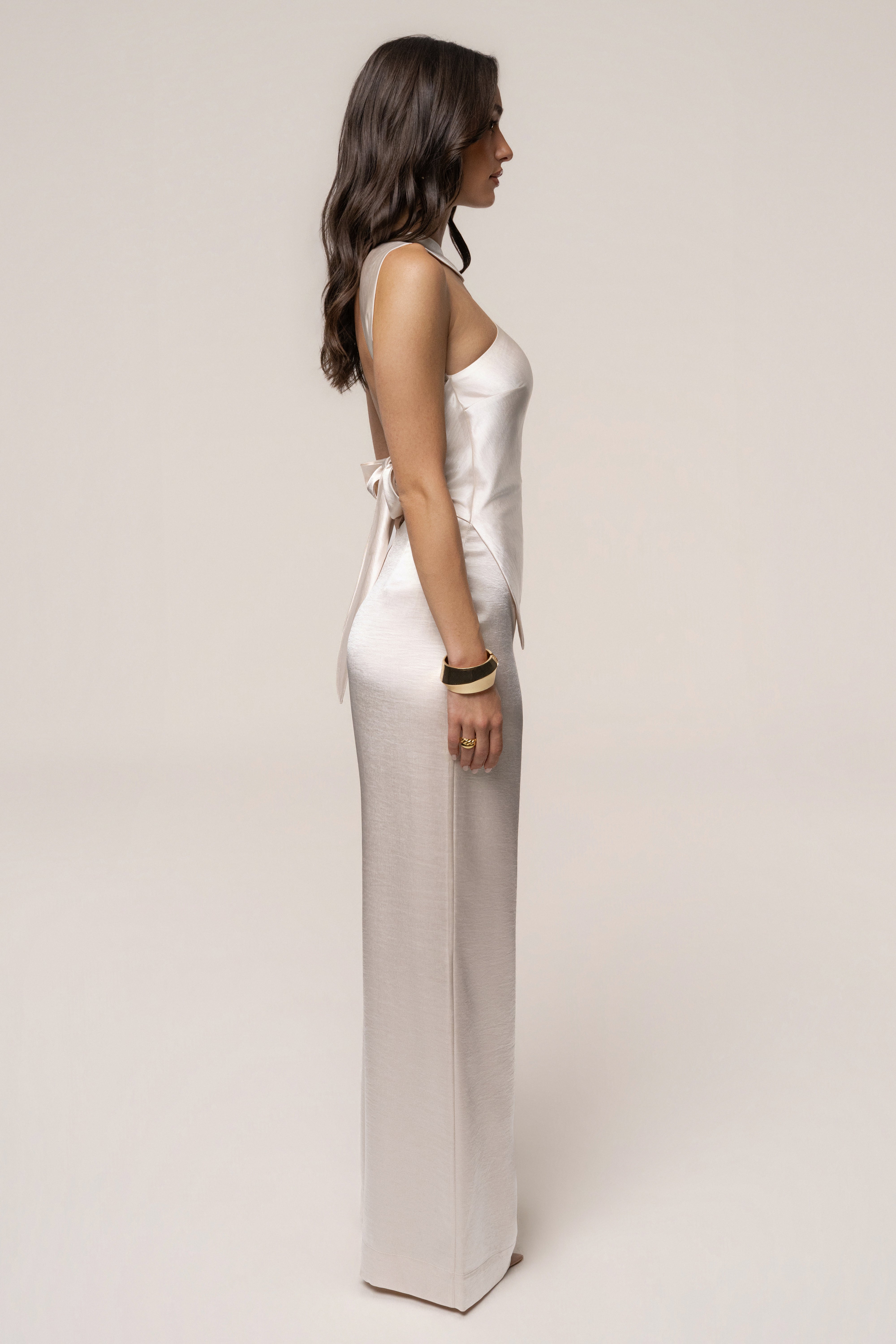 Ivory JLUXLABEL Premiere one-shoulder jumpsuit displayed on a hanger, showcasing its sleek design and elegant style.