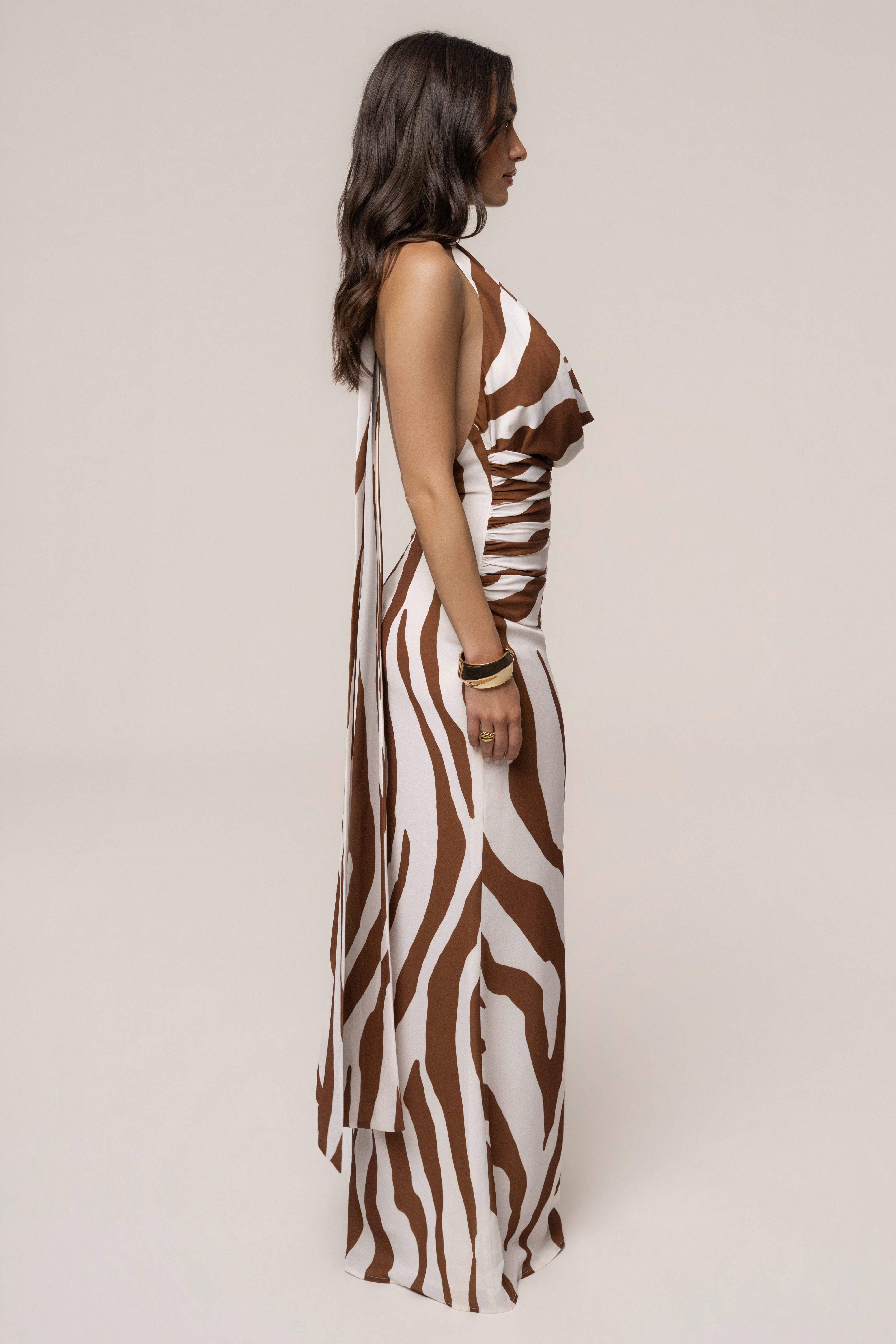 Brown Zebra Impressions plunge maxi dress by JLUXLABEL, featuring a bold animal print and flowing silhouette.