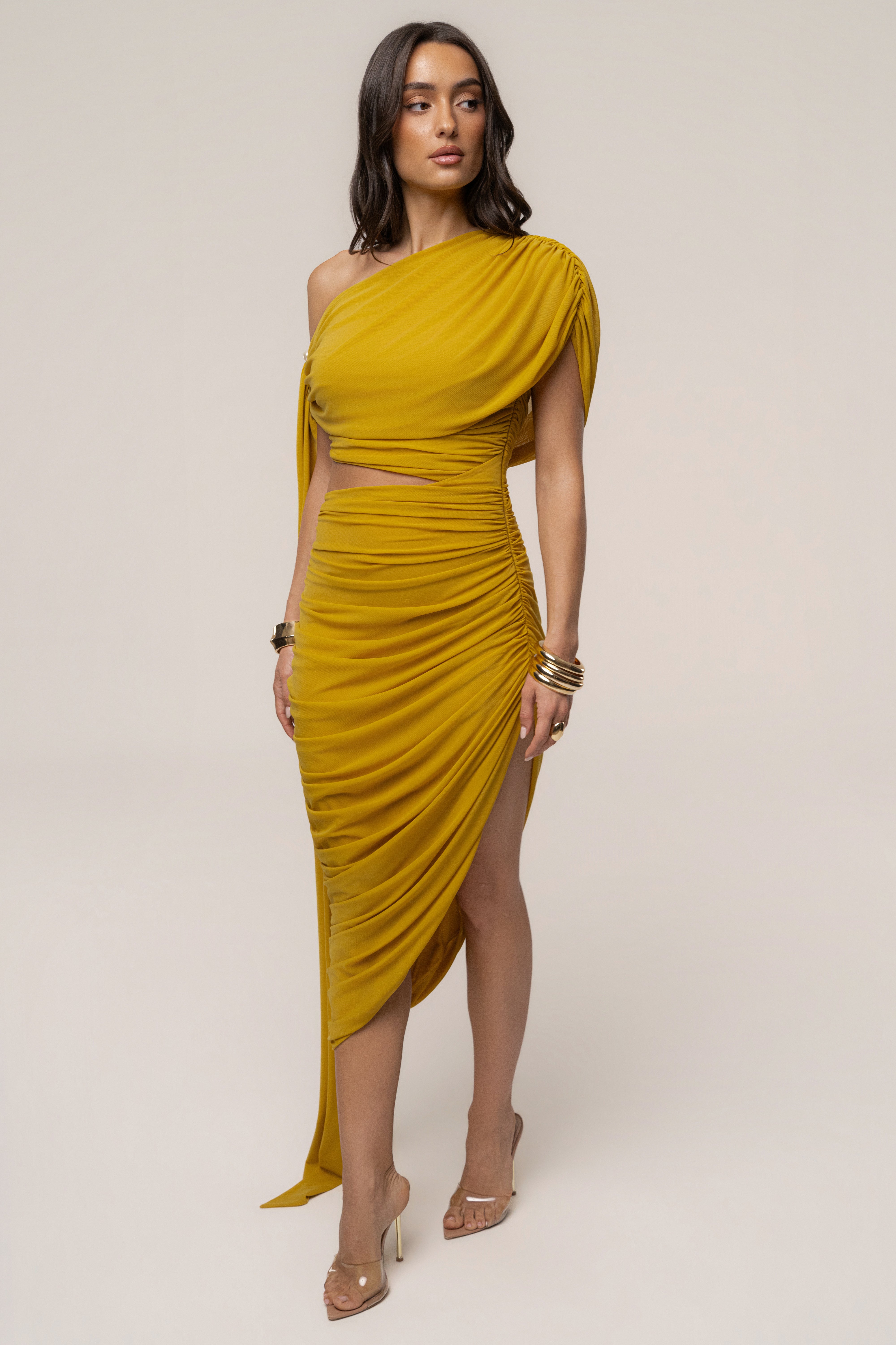 Mustard Aris cutout midi dress by JLUXLABEL, featuring stylish design and mid-length silhouette, shown on a model.