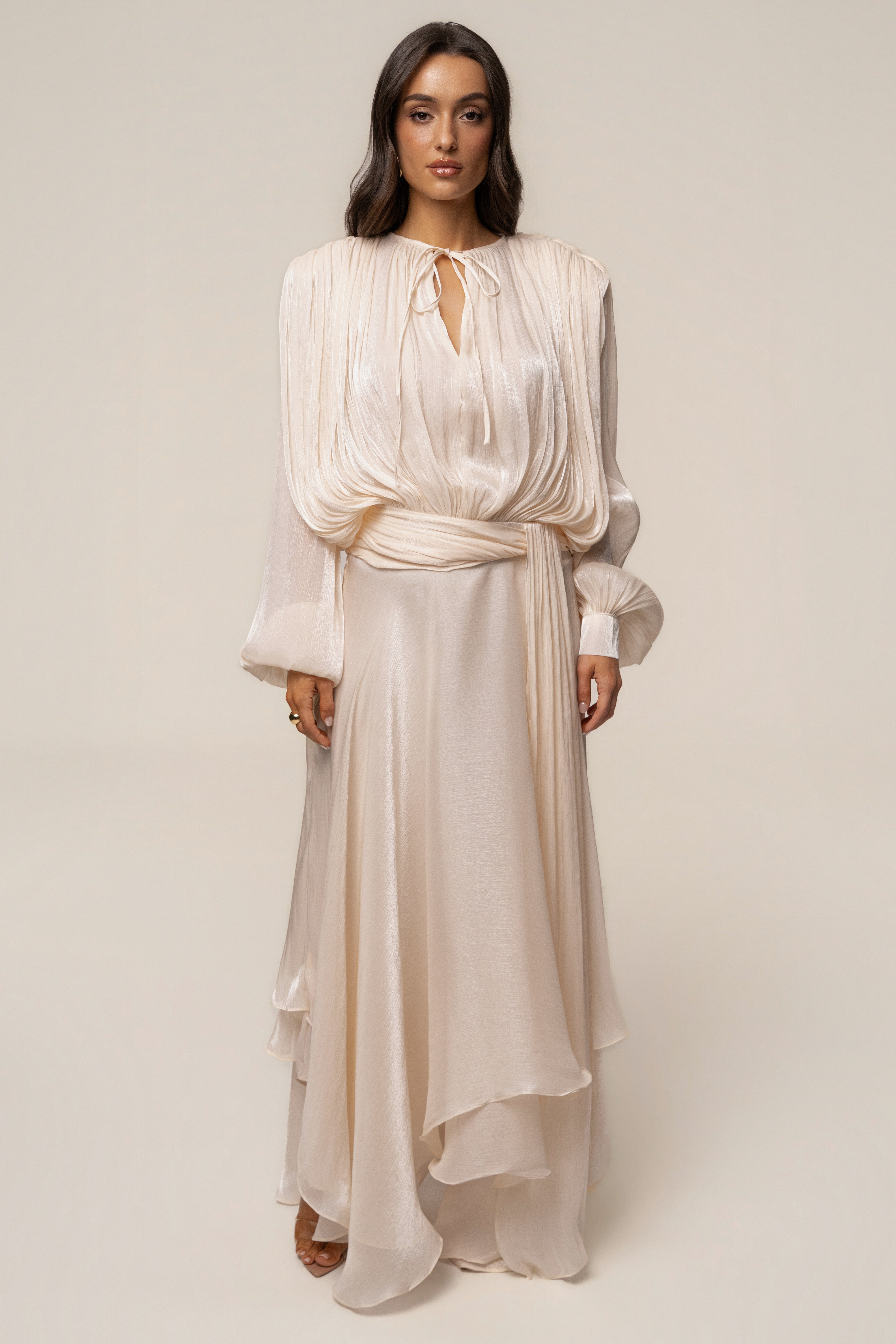 Cream draped maxi dress by JLUXLABEL featuring elegant flowing fabric and a sophisticated design.