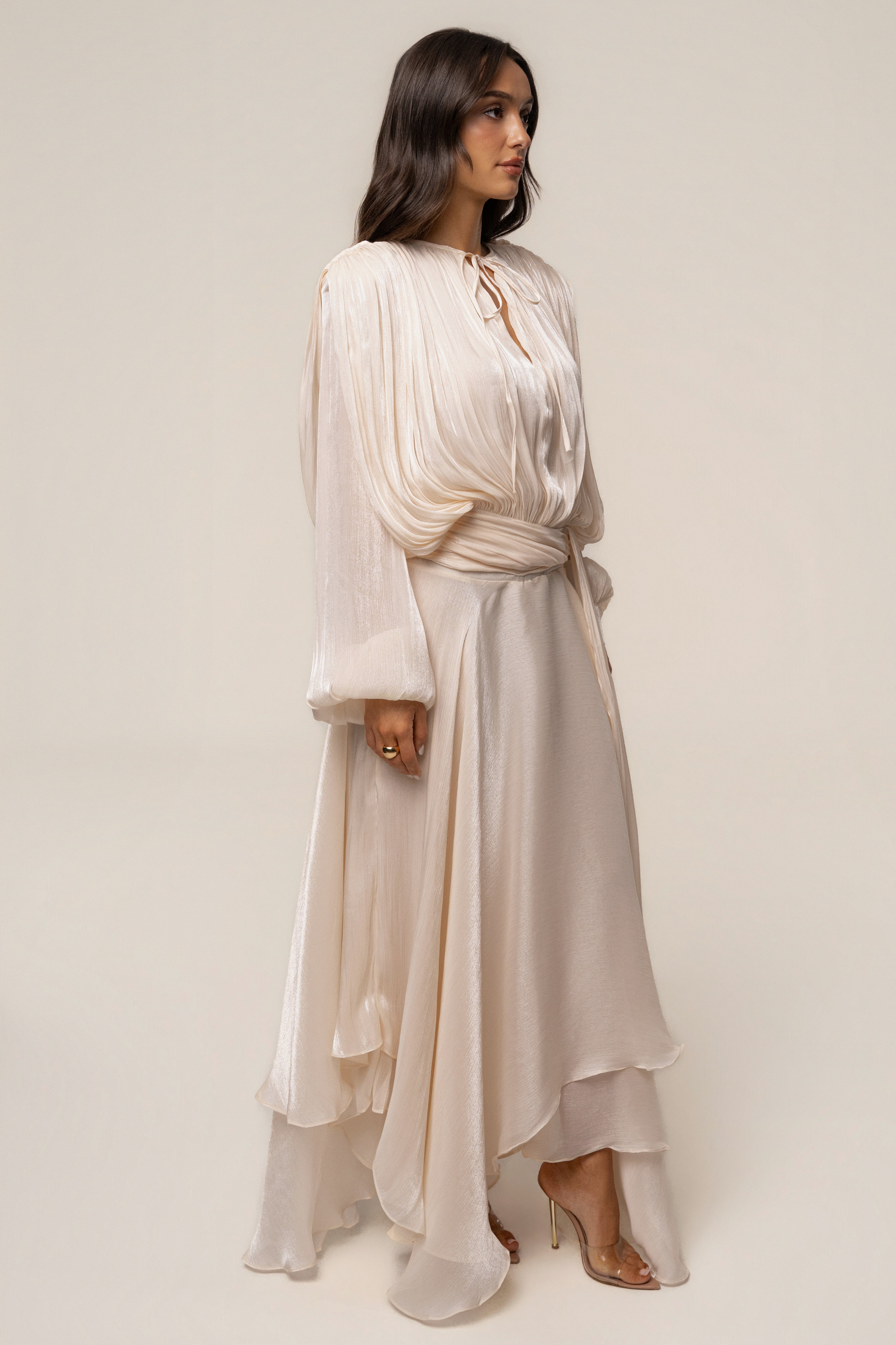 Cream Draped In Elegance maxi dress by JLUXLABEL, showcasing a flowy, draped design with elegant fabric and styling.