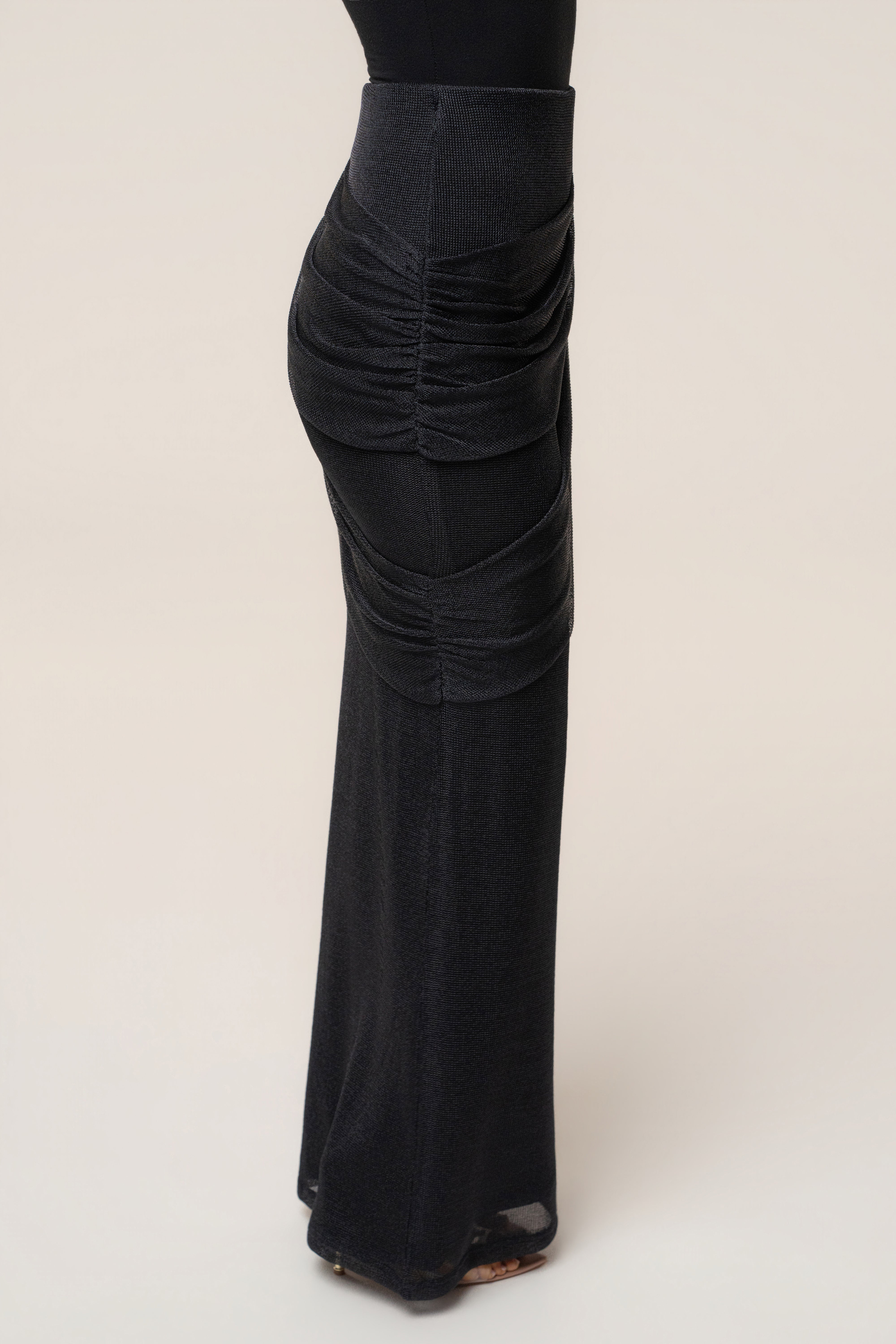 Black opulent metallic maxi skirt from JLUXLABEL featuring a flowing, shiny fabric and elegant design for formal occasions.