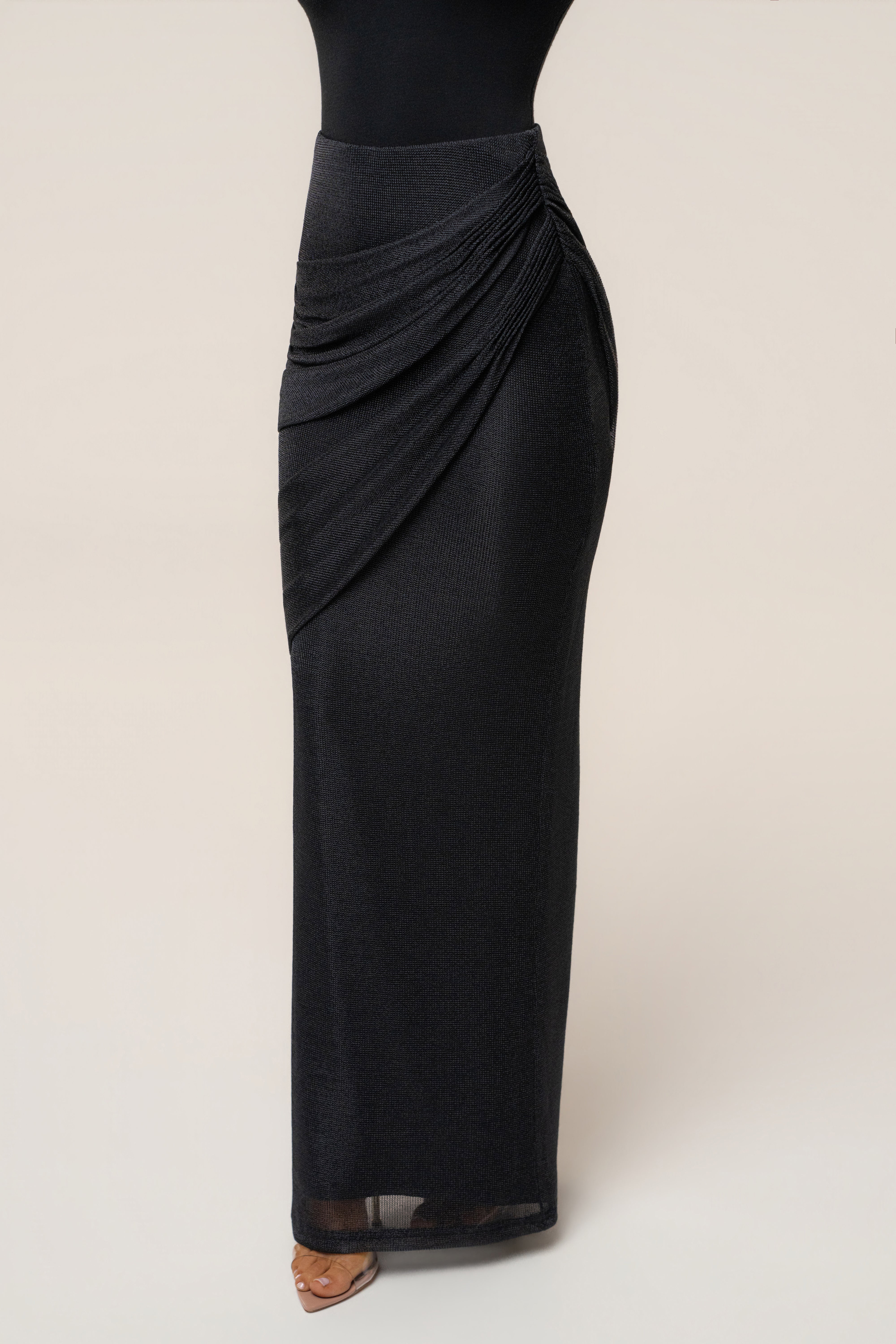 Black opulent metallic maxi skirt from JLUXLABEL, featuring a flowing design with a shiny, luxurious finish.