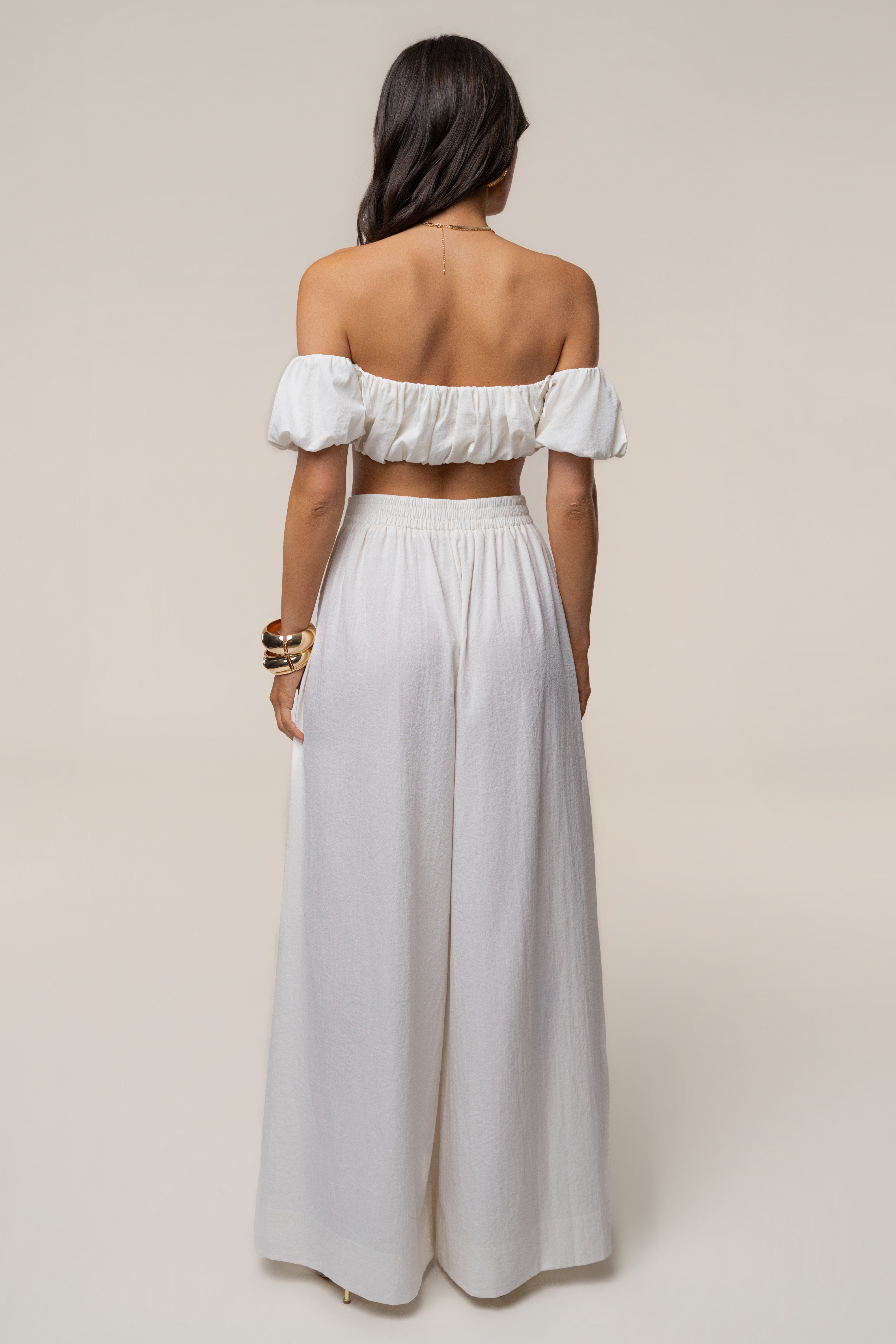 Back view of ivory Sunset Breeze Pant Set with off-shoulder crop top and wide-leg pants