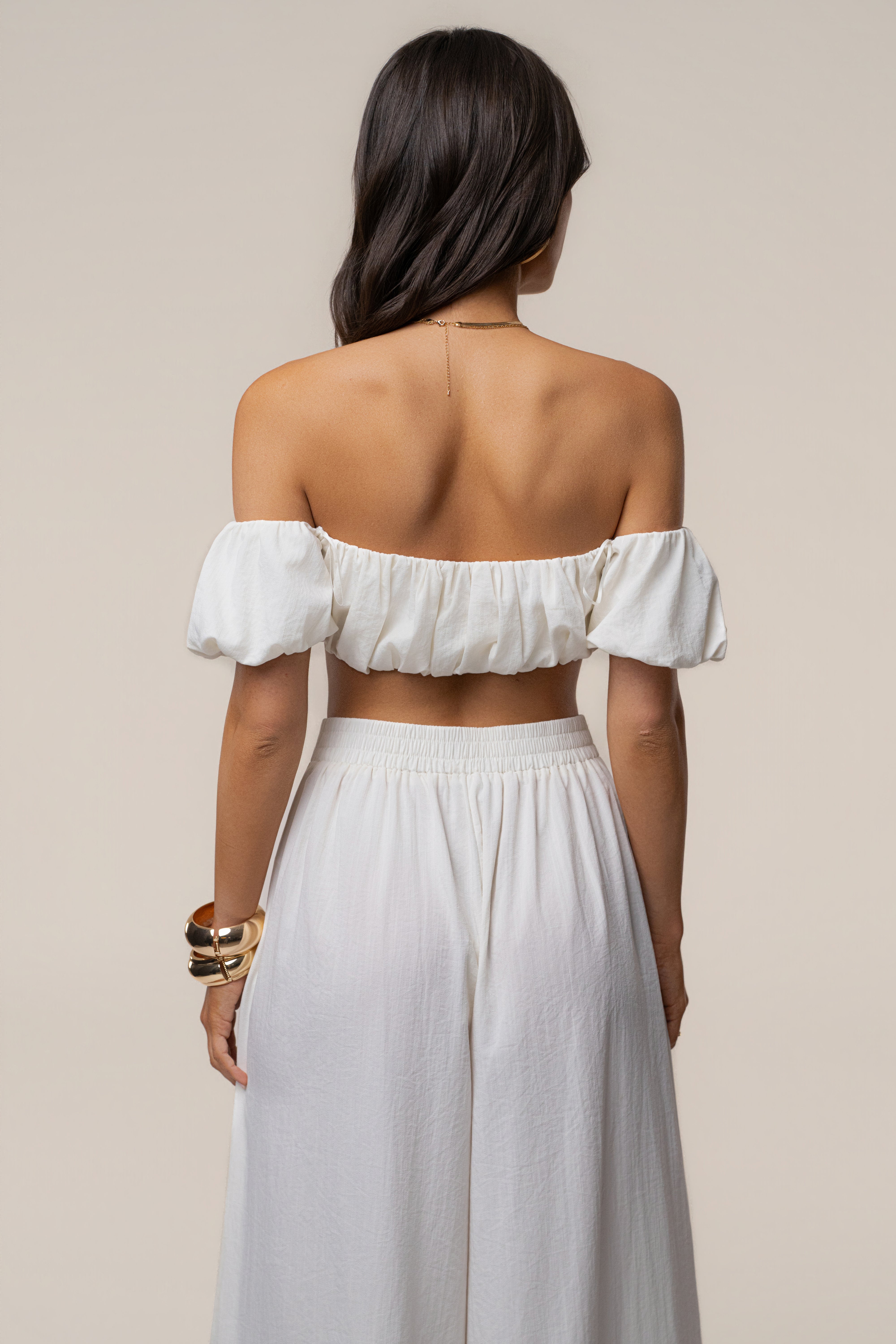 Back view of ivory Sunset Breeze Pant Set showing an off-shoulder neckline and gathered elastic waist pants