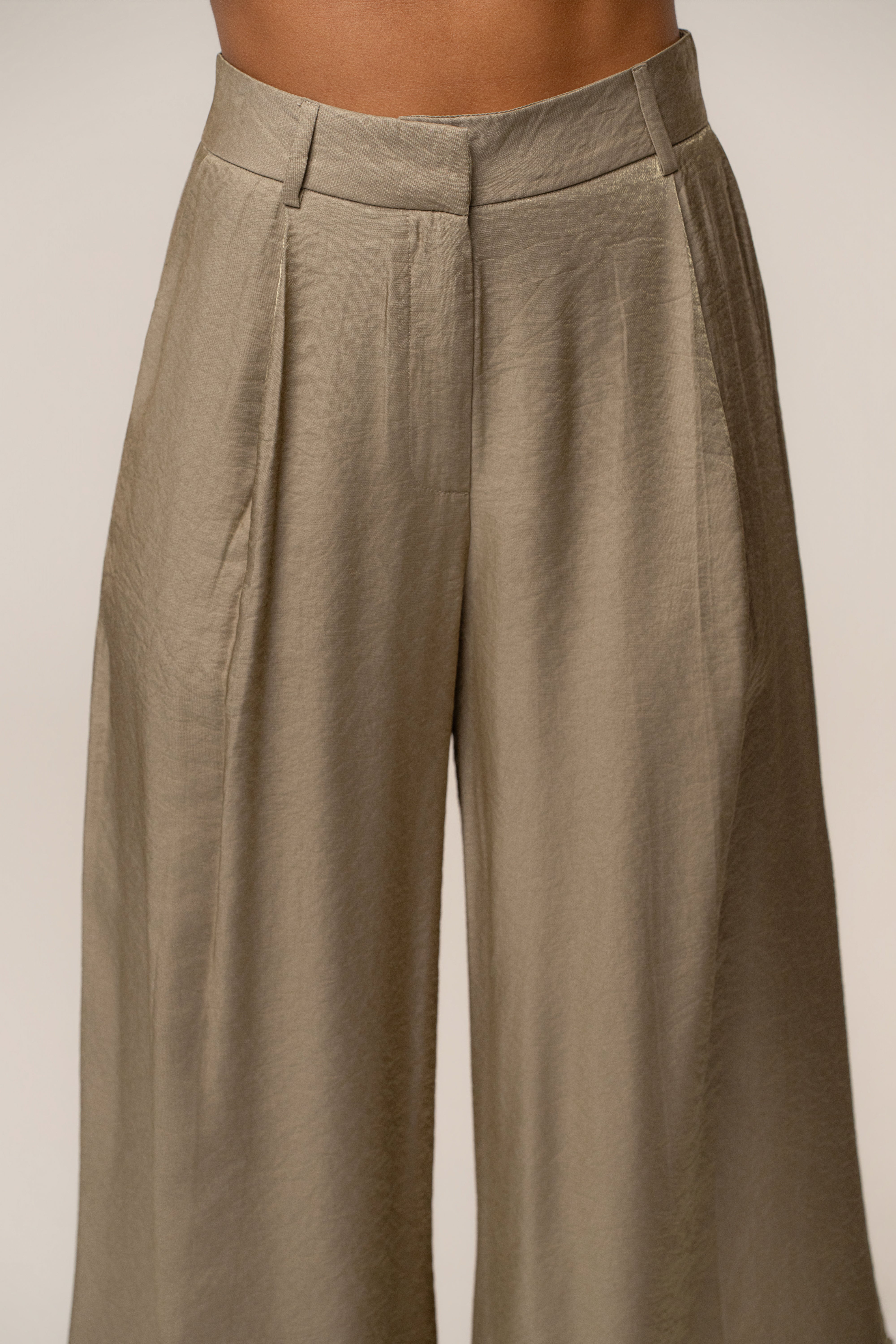 Close up of the olive Monaco wide leg pants waist showing belt loops and tailored waistband