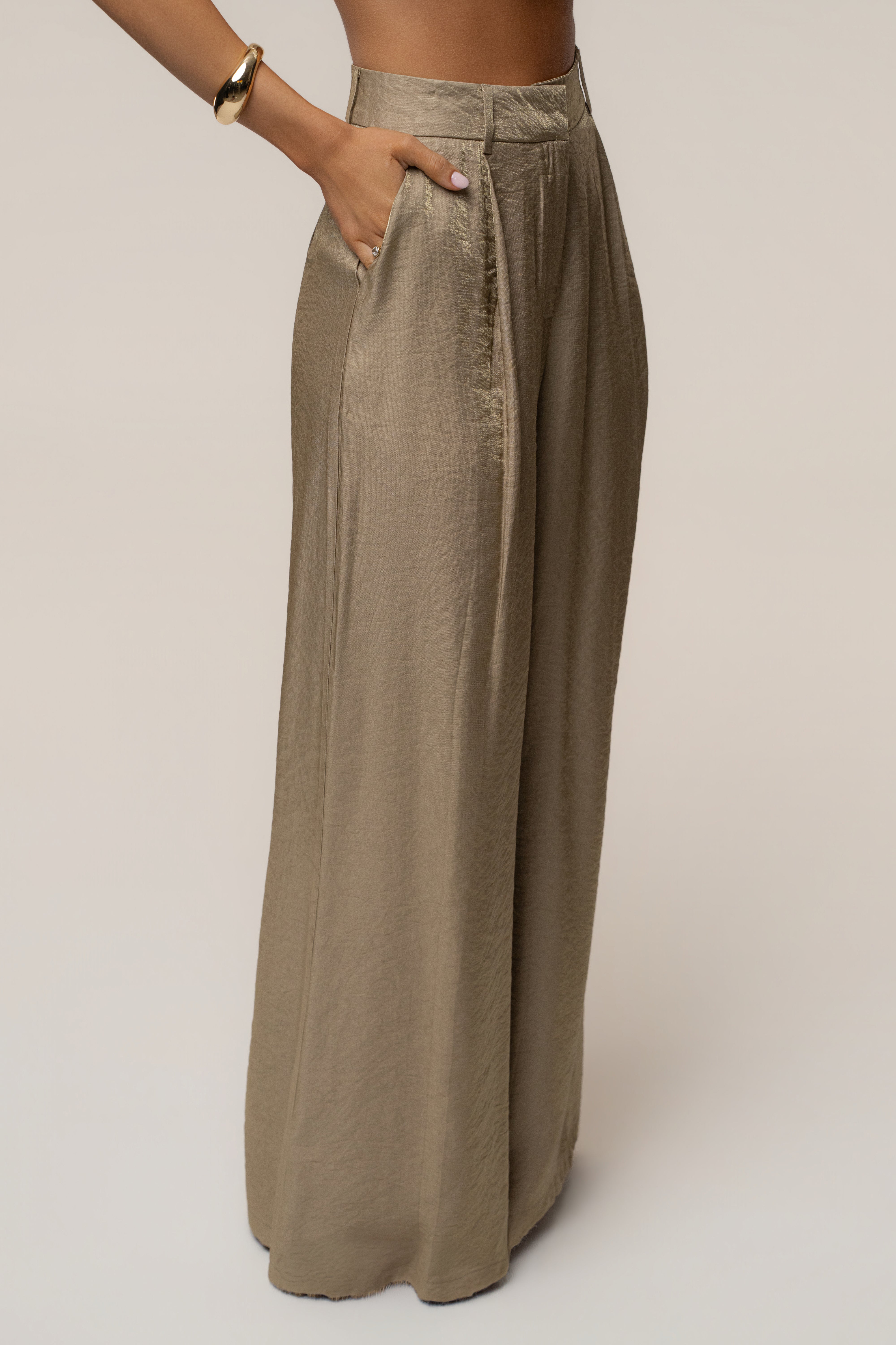 Side view of metallic olive Monaco wide leg pant with pocket and high waist.