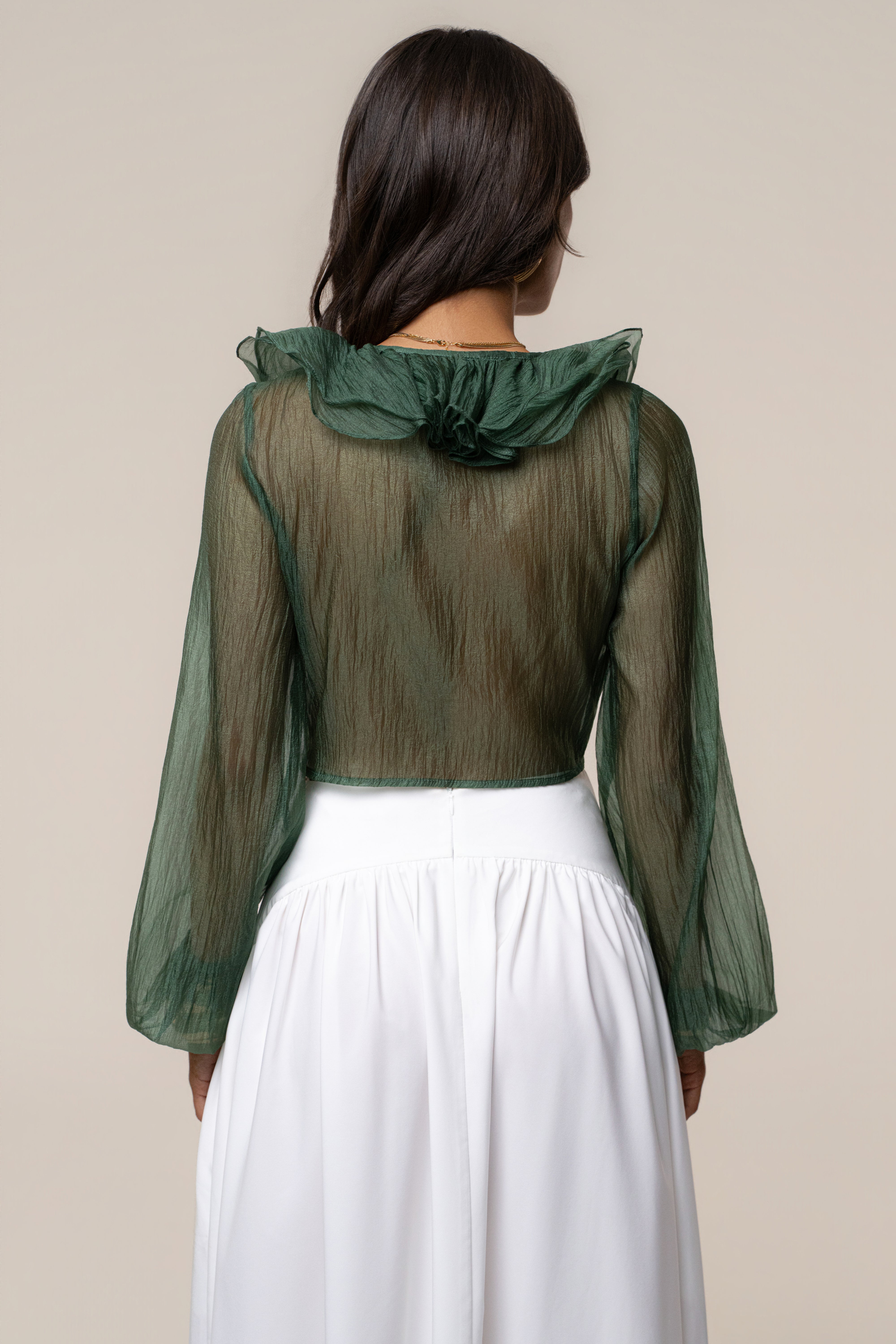 Back view of sheer green Delilah Ruffled Top showing cropped length and wide ruffled collar at the back