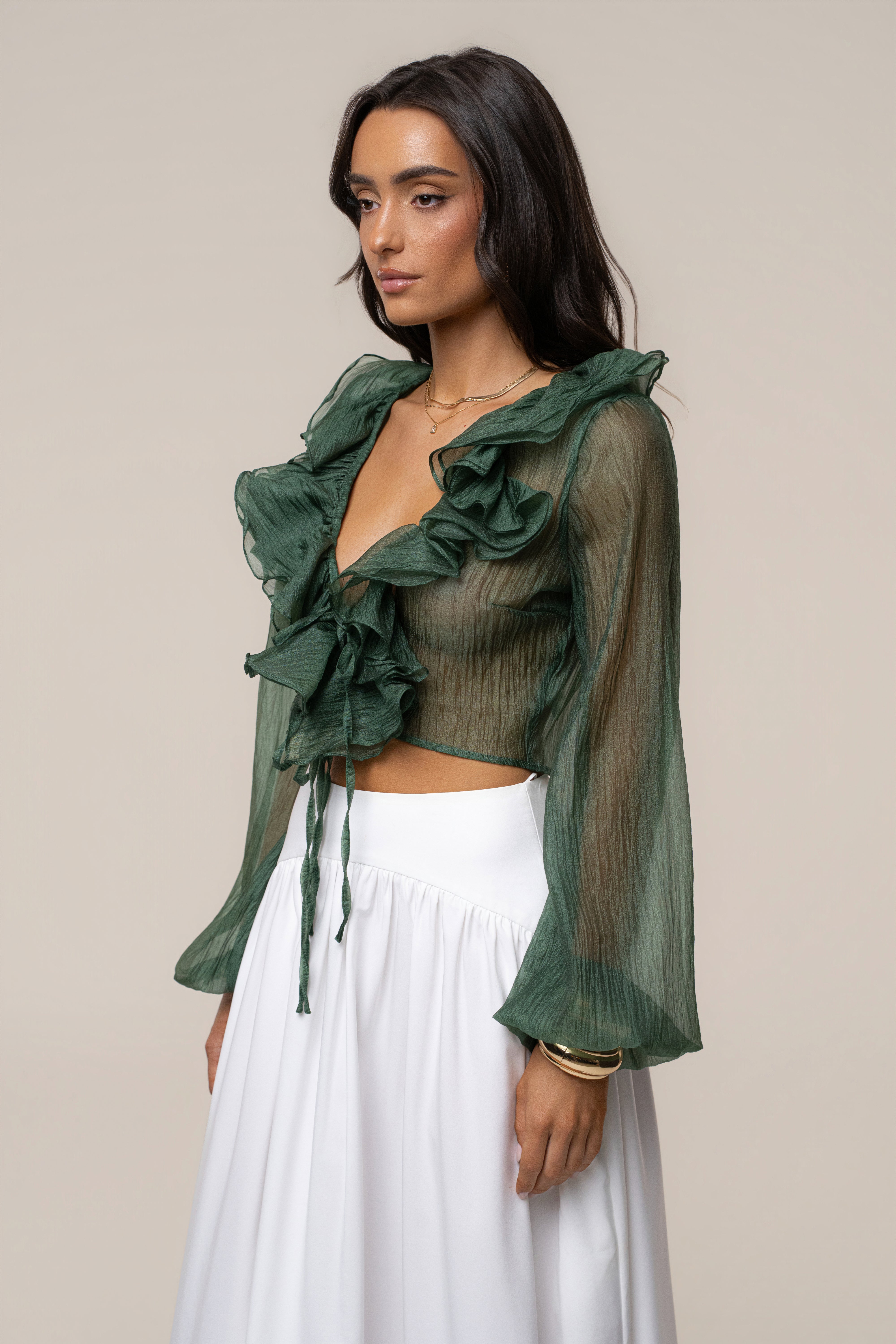 Close up of green sheer Delilah top with dramatic ruffles and front ties