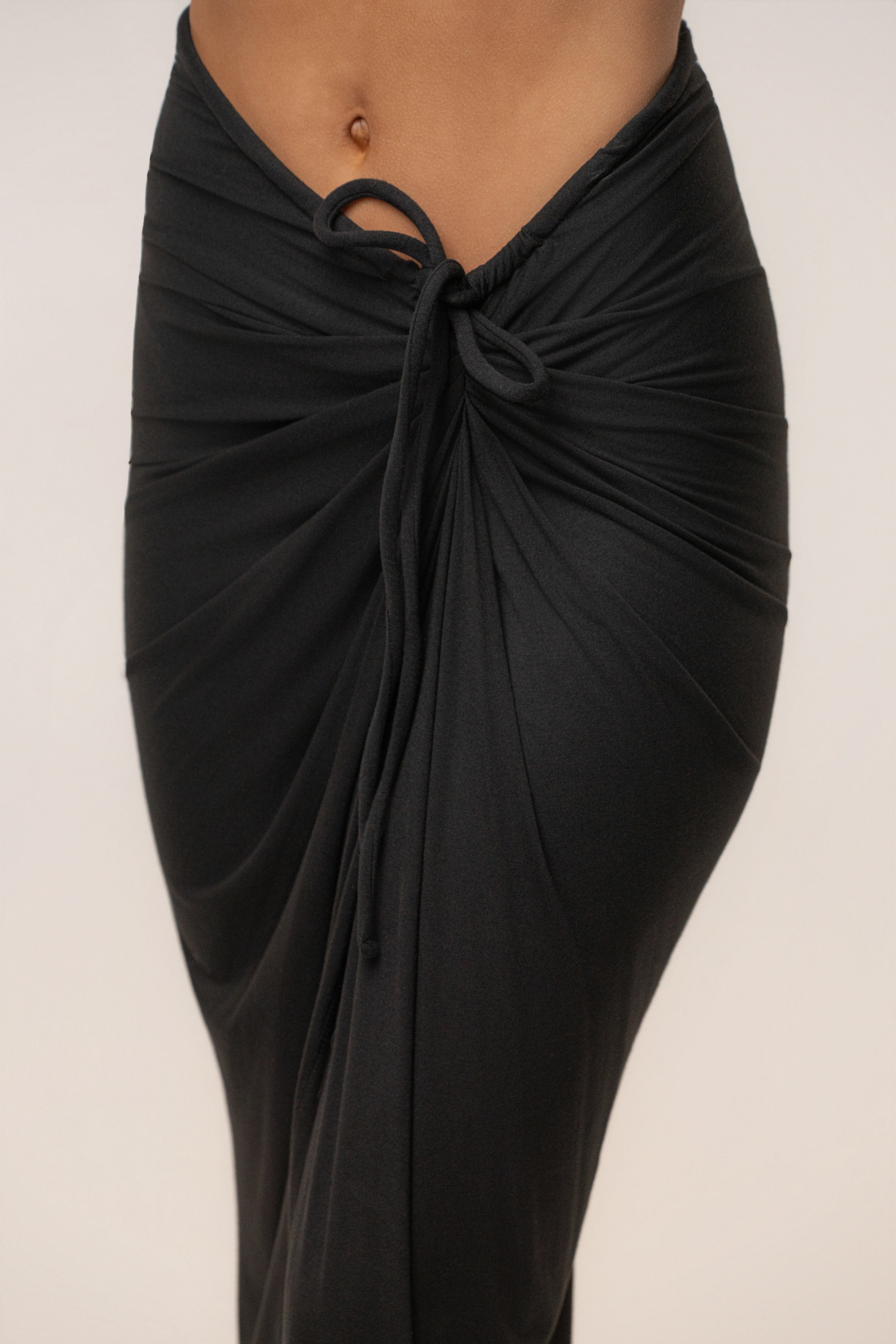 Black Island Drape Maxi Skirt from JLUXLABEL featuring a flowy, draped design and ankle-length silhouette.