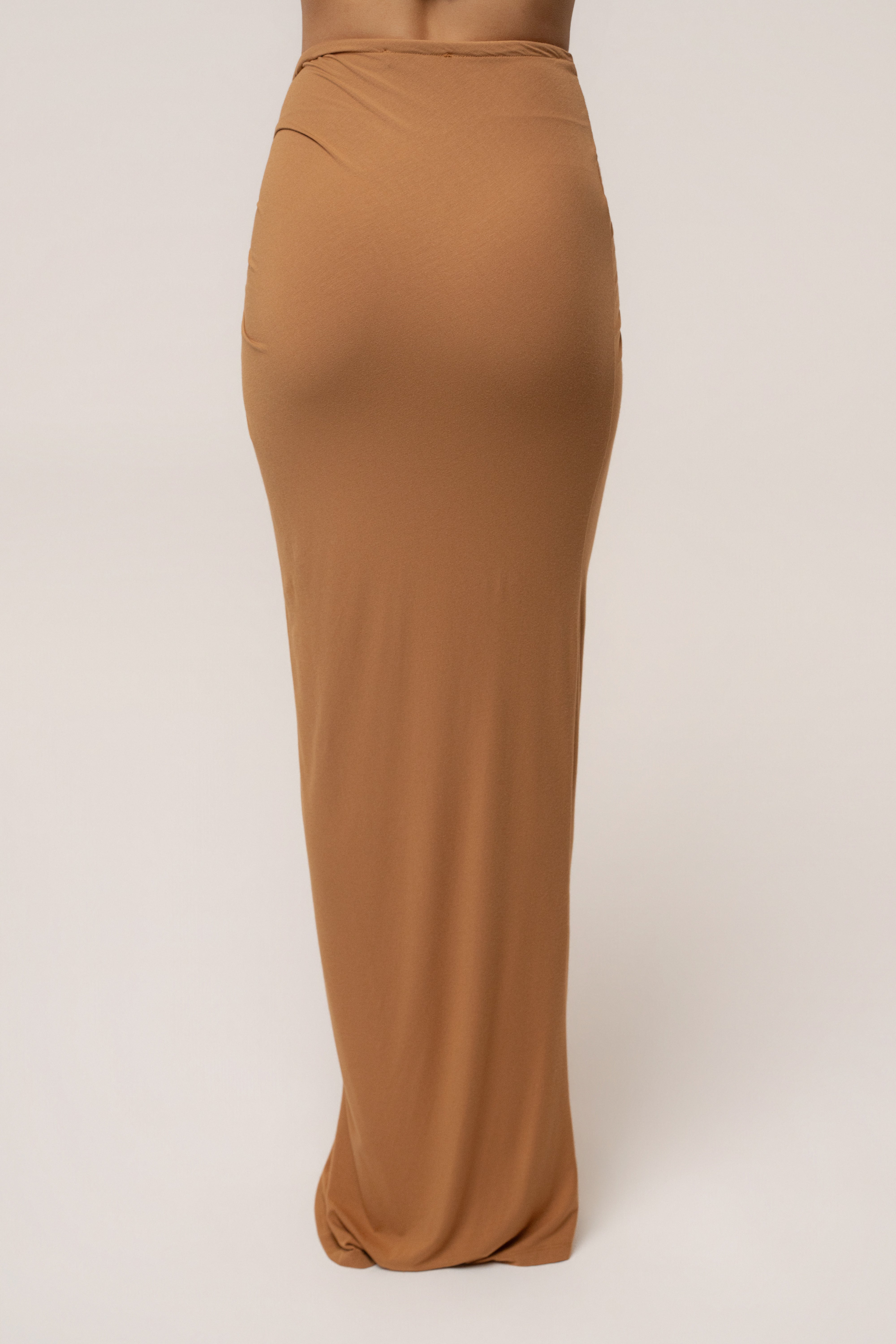 Tan JLUXLABEL Island Drape Maxi Skirt with flowing fabric and waist tie, styled as a stylish boho-bottoms look.