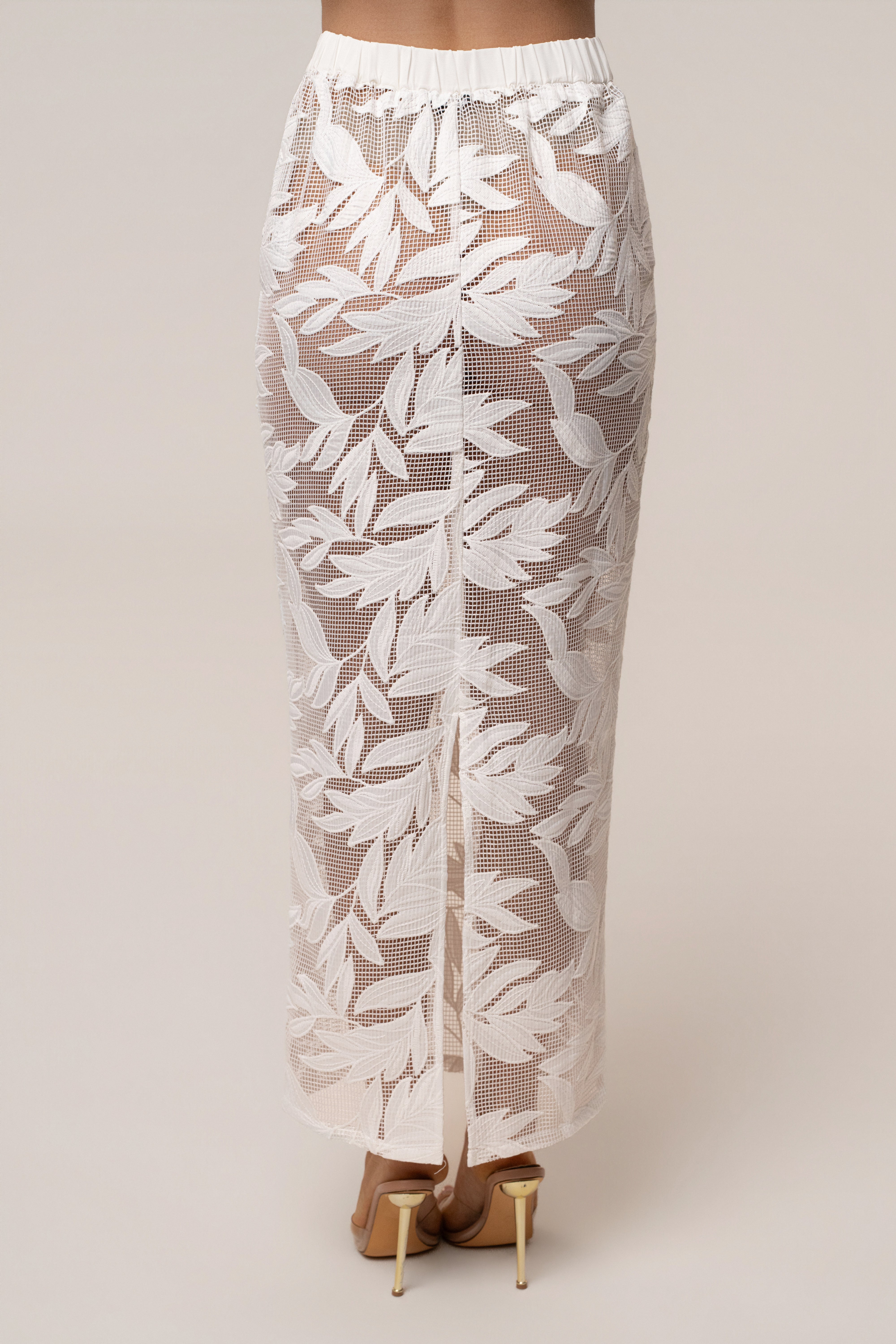 White Bali Nights embroidered skirt by JLUXLABEL, featuring intricate embroidery and lightweight fabric, styled as a stylish bottom piece.