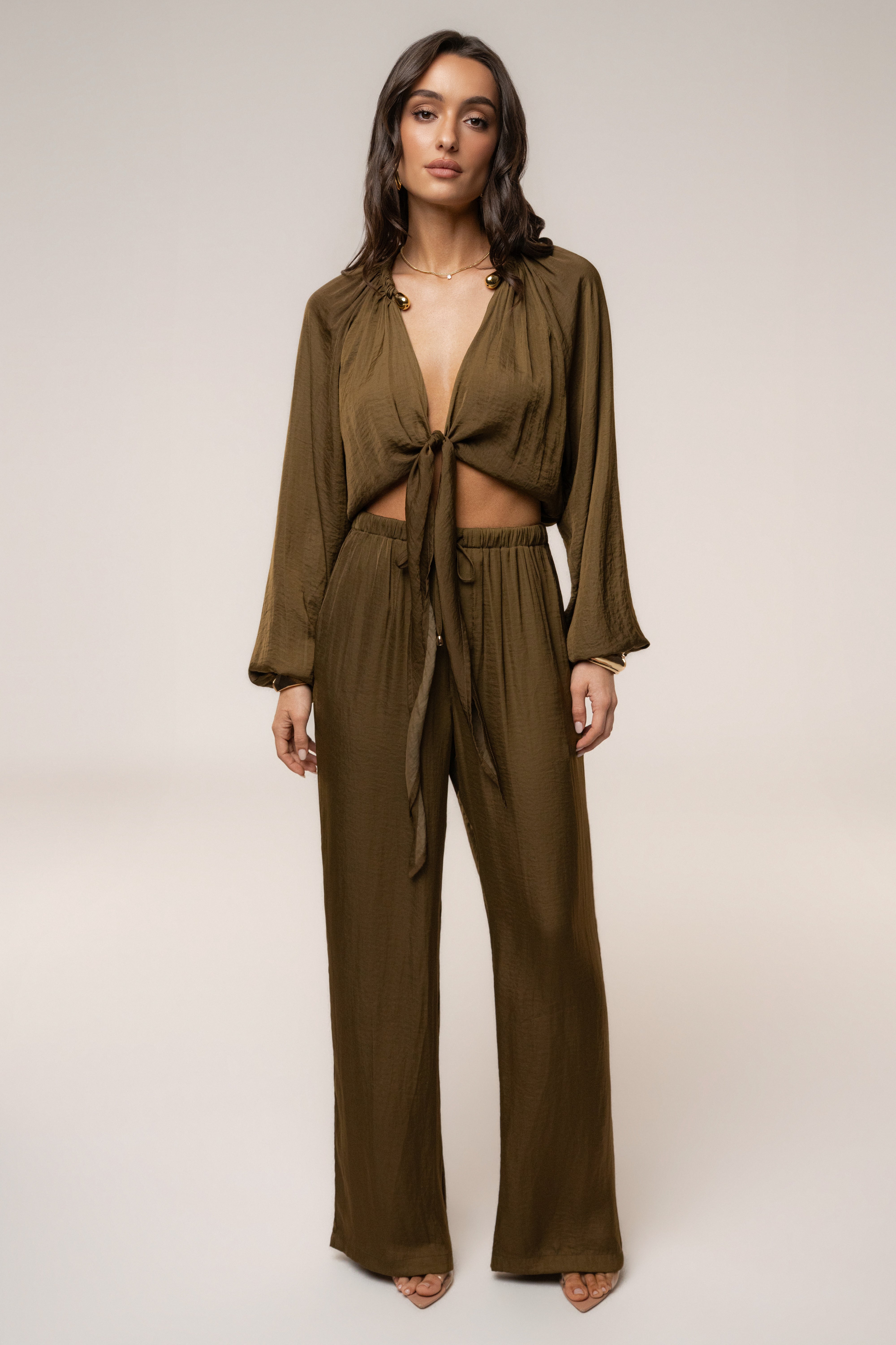 Olive Seaside Glow Pants by JLUXLABEL, stylish bottoms with a relaxed fit and subtle sheen, perfect for casual or dressy occasions.