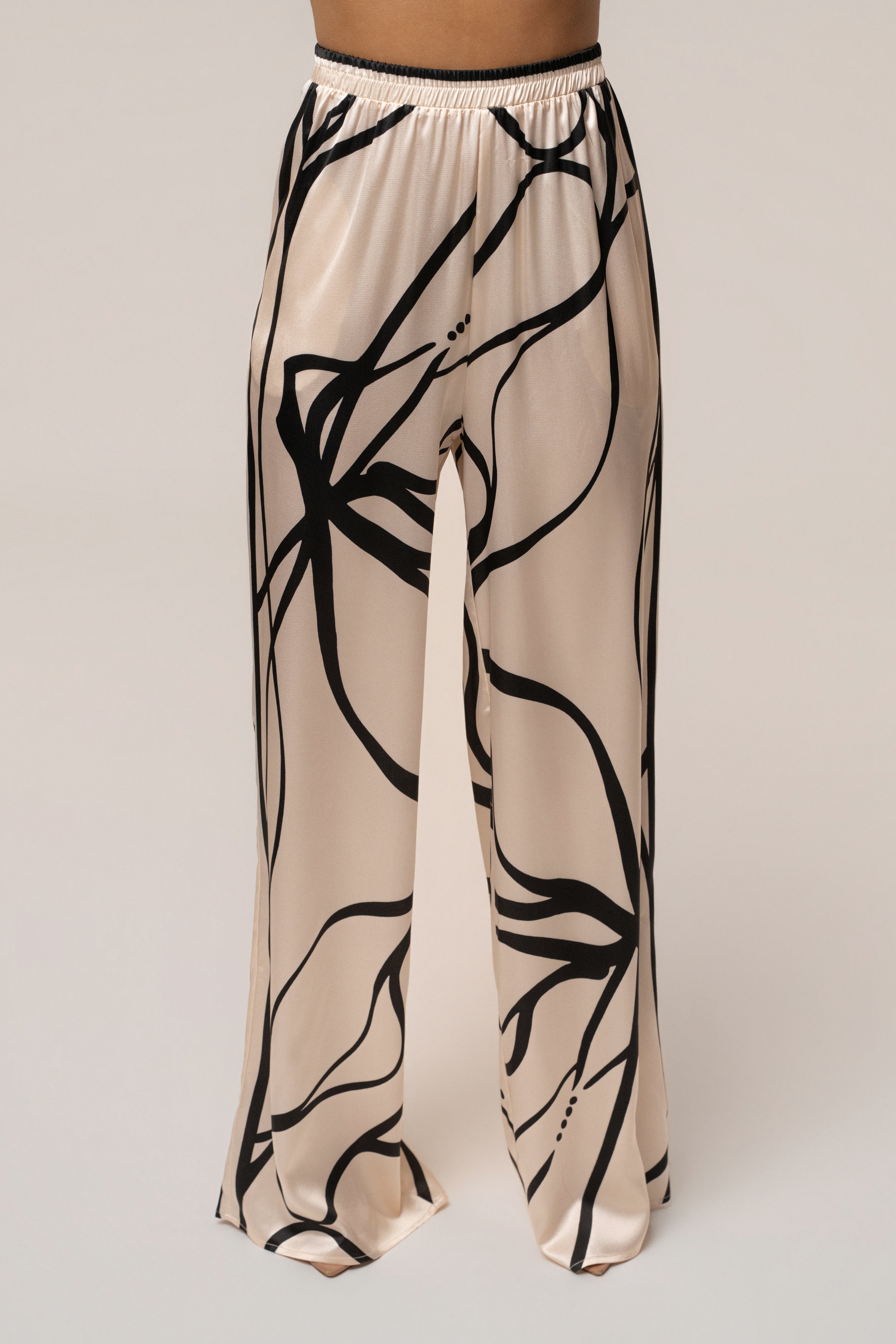 Cream and black art form pant set by JLUXLABEL, featuring stylish high-waisted pants and a matching top in a chic design.