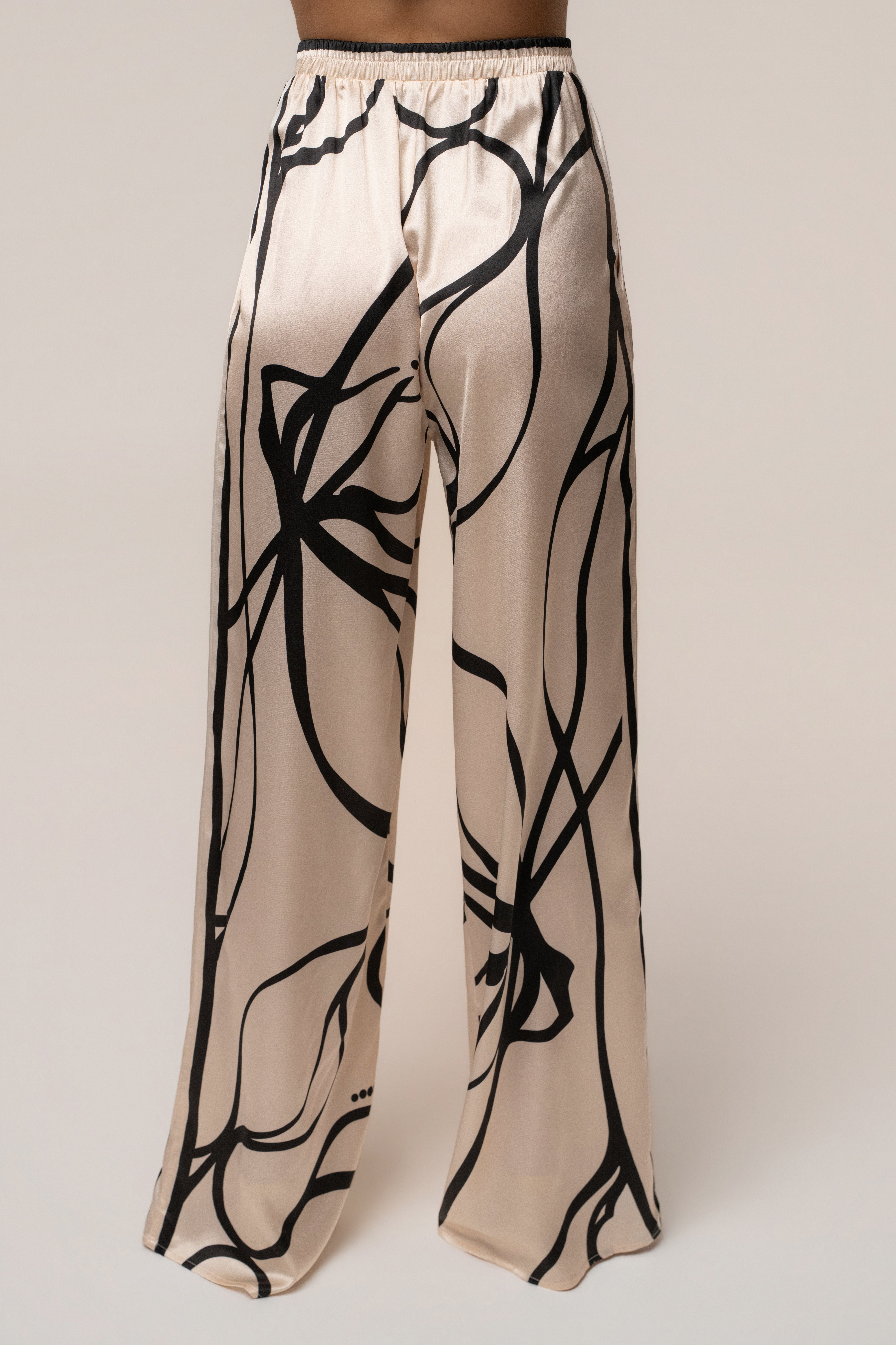 Cream and black Art Form pant set by JLUXLABEL featuring stylish, comfortable matching top and pants ensemble.