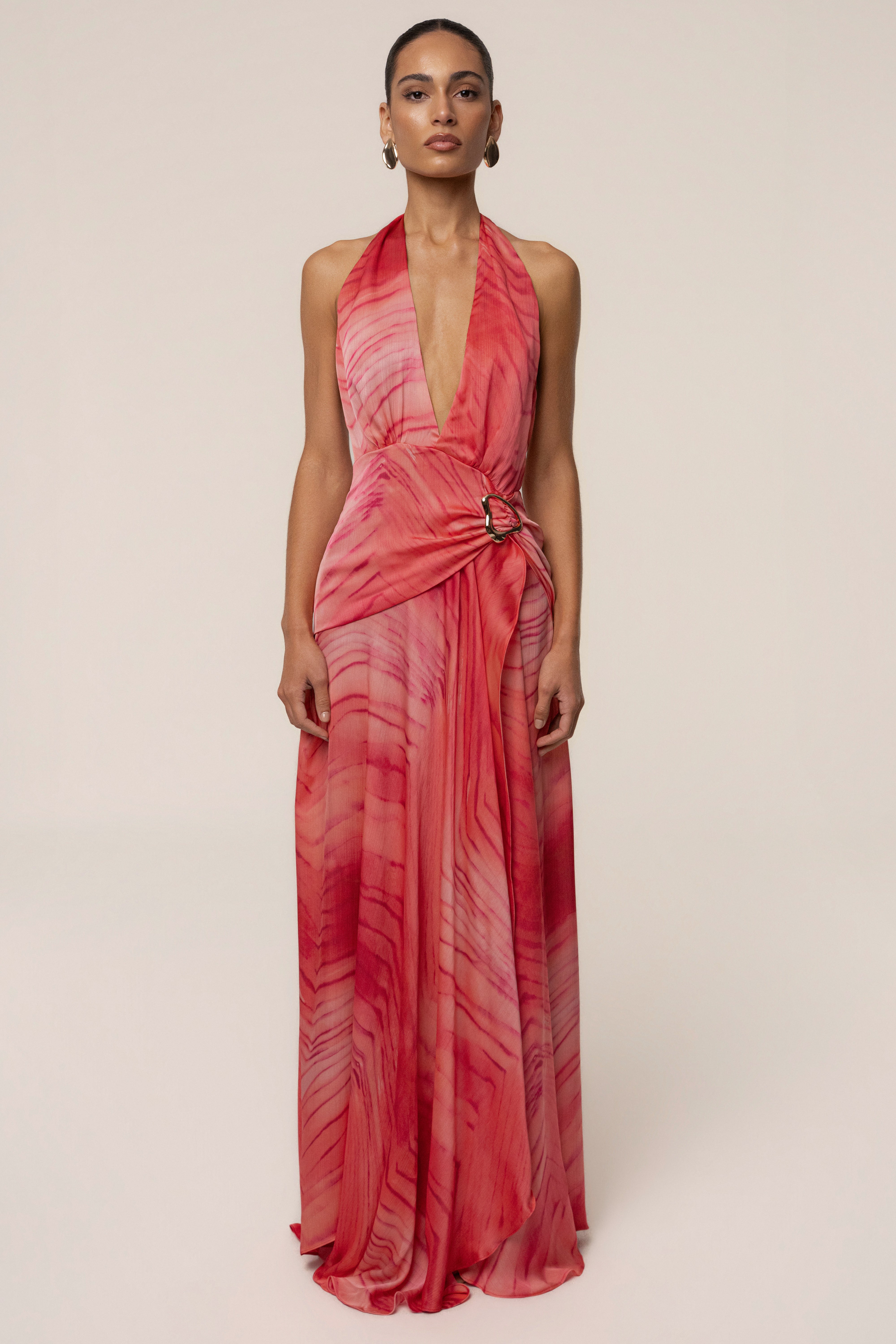 Full-length coral red Vacation State maxi dress with halter neckline and flowing wrap skirt.