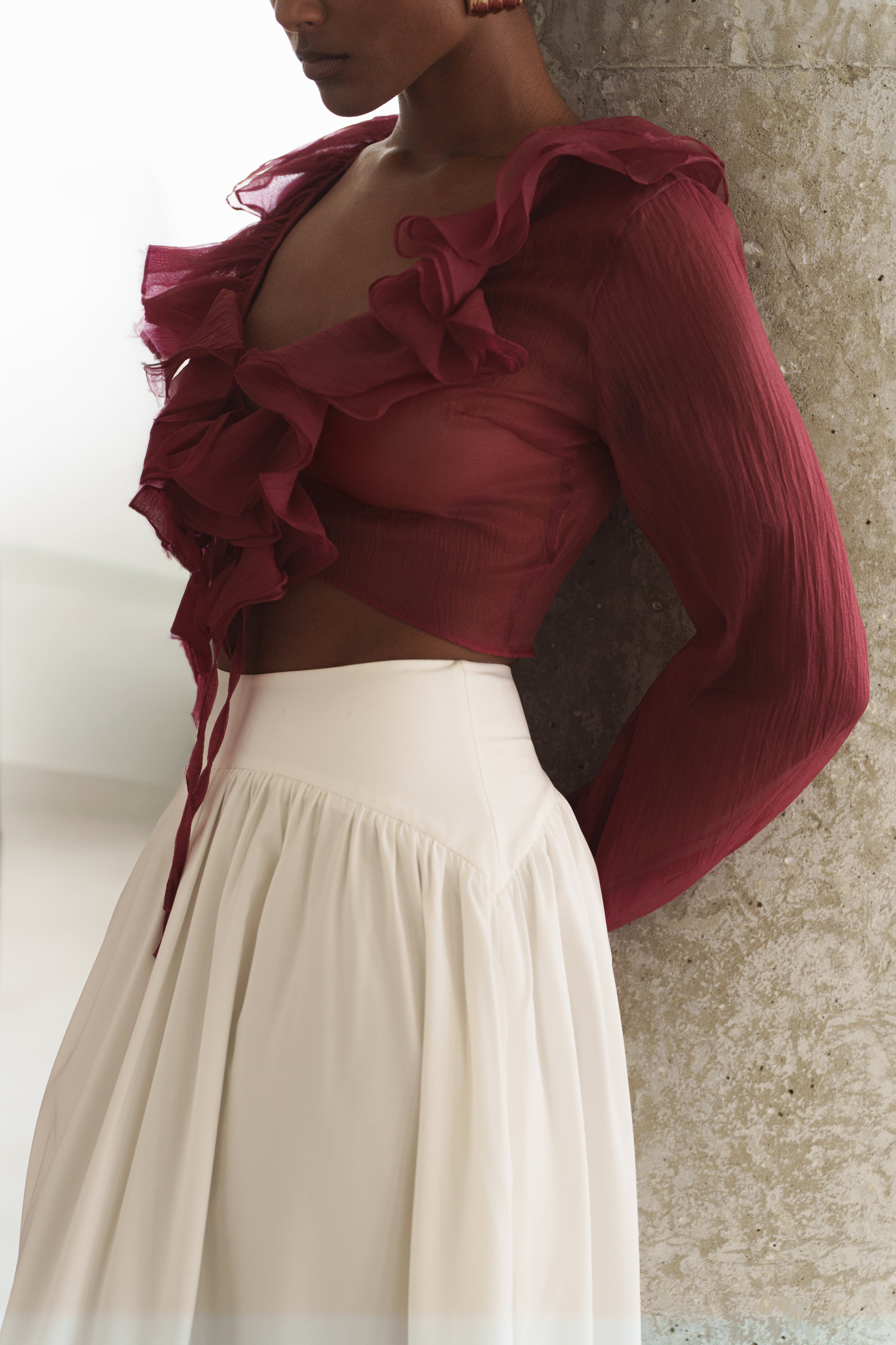 Close-up of a burgundy Berry Delilah Ruffled Top with a cropped neckline and voluminous ruffles.