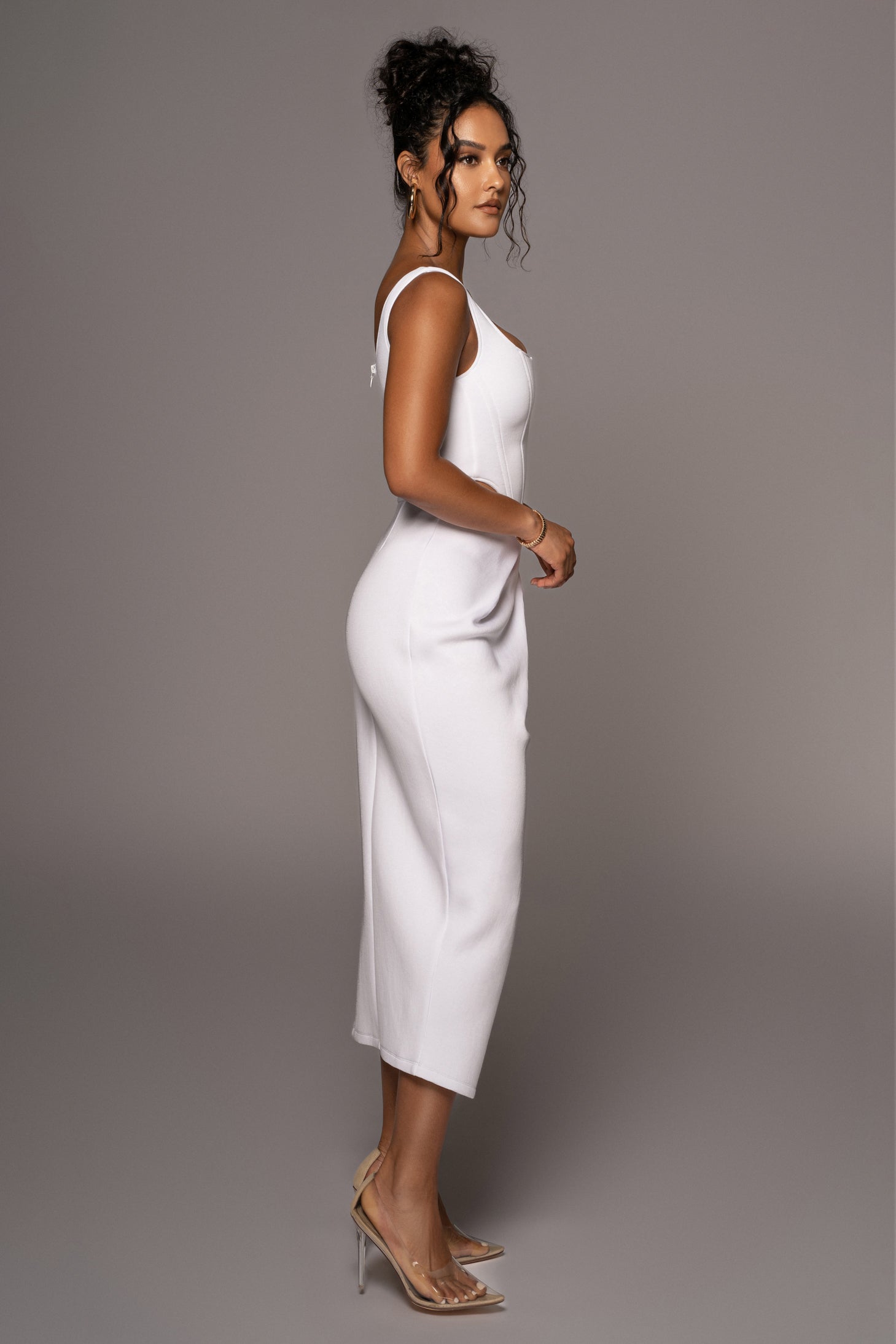 White Roxanne slit skirt by JLUXLABEL, featuring a stylish slit design, shown laid flat with smooth fabric and clean seams.